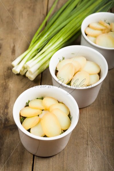 Potato with greenery in the cups for baking – Stock photos from around the world